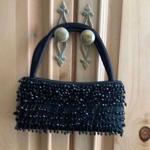 Small black satin evening bag with magnetic closure